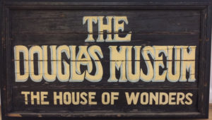 Sign for The Douglas Museum - The House of Wonders