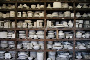 Gladstone pottery, an abundance of ceramic moulds on wooden shelves